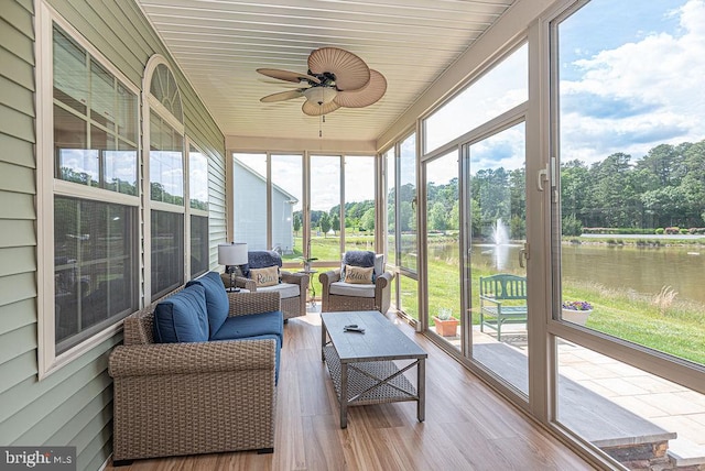 24440 Harvest Cir, Milton, DE 19968 - sunroom / solarium featuring a water view, outdoor lounge area, a ceiling fan, and view of wooded area