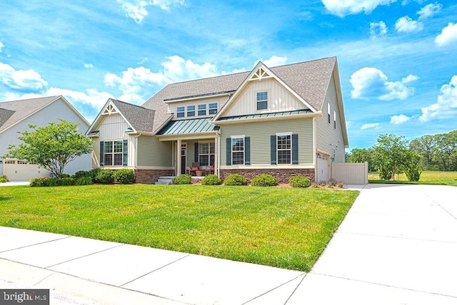 24440 Harvest Cir, Milton, DE 19968 - craftsman-style home featuring a standing seam roof, board and batten siding, stone siding, a front yard, and concrete driveway