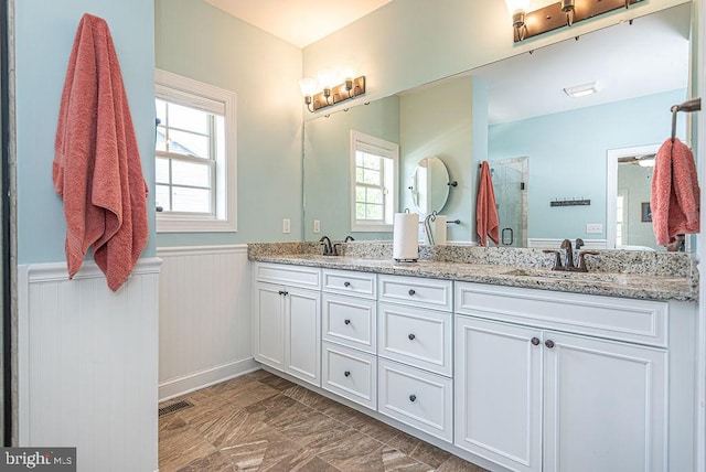 24440 Harvest Cir, Milton, DE 19968 - full bath with a wainscoted wall, healthy amount of natural light, double vanity, and an enclosed shower