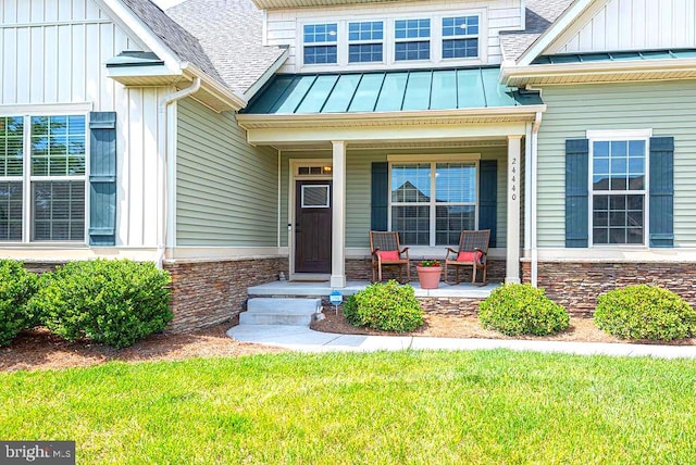 24440 Harvest Cir, Milton, DE 19968 - doorway to property featuring a shingled roof, a porch, a standing seam roof, and board and batten siding