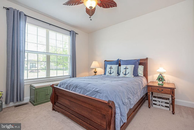 24440 Harvest Cir, Milton, DE 19968 - bedroom with multiple windows, light carpet, baseboards, and ceiling fan