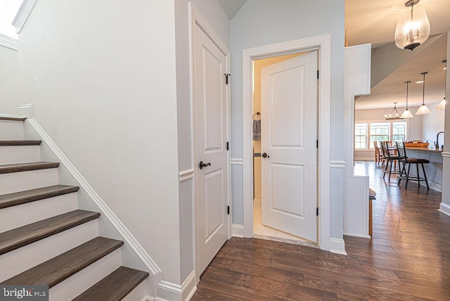 24440 Harvest Cir, Milton, DE 19968 - staircase with hardwood / wood-style flooring, baseboards, and a chandelier
