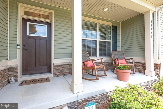 24440 Harvest Cir, Milton, DE 19968 - entrance to property featuring covered porch and stone siding