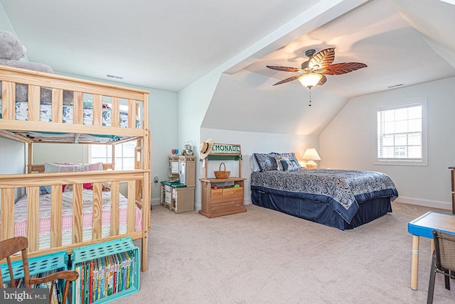 24440 Harvest Cir, Milton, DE 19968 - carpeted bedroom featuring multiple windows, vaulted ceiling, ceiling fan, and baseboards