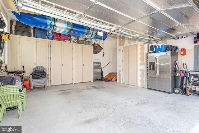 24440 Harvest Cir, Milton, DE 19968 - garage featuring stainless steel fridge and a garage door opener