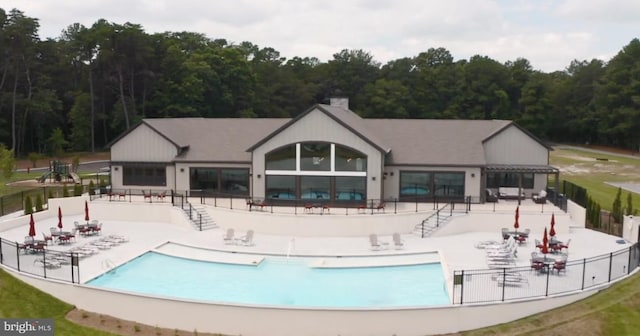 24440 Harvest Cir, Milton, DE 19968 - community pool with a patio and a wooded view