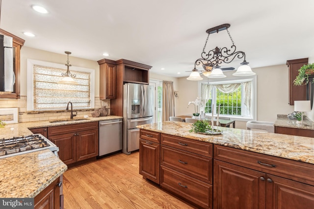 105 Lombardy Dr, Wallingford, PA 19086 - kitchen featuring stainless steel appliances, a sink, pendant lighting, backsplash, and light wood-style flooring