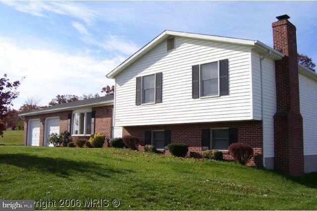 1300 Campus Ct, Westminster, MD 21157 - tri-level home featuring brick siding, a chimney, a front yard, and a garage