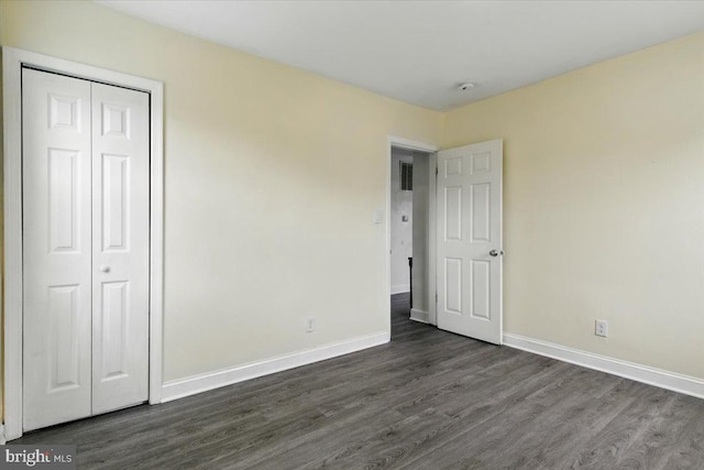 1209 Chapel Oaks Dr, Capitol Heights, MD 20743 - unfurnished bedroom featuring dark wood-type flooring, baseboards, and a closet