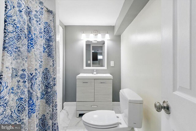 1209 Chapel Oaks Dr, Capitol Heights, MD 20743 - full bathroom featuring toilet, marble look tiles, vanity, curtained shower, and baseboards