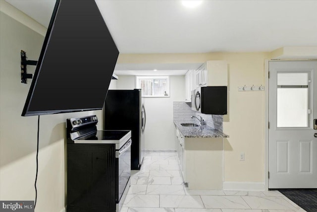 1209 Chapel Oaks Dr, Capitol Heights, MD 20743 - kitchen with appliances with stainless steel finishes, a sink, baseboards, and light marble finish floors