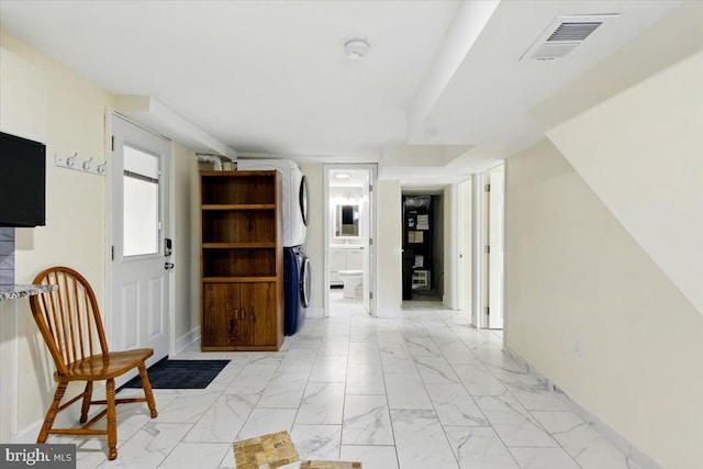 1209 Chapel Oaks Dr, Capitol Heights, MD 20743 - foyer with stacked washer / drying machine, light marble finish floors, and baseboards