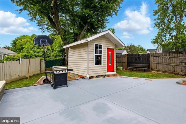 1209 Chapel Oaks Dr, Capitol Heights, MD 20743 - fenced backyard with a patio area, grilling area, and an outdoor structure