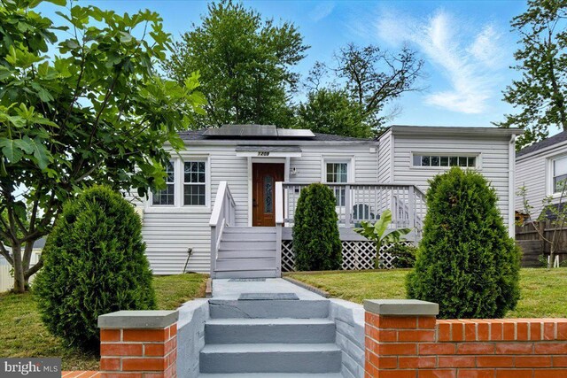 1209 Chapel Oaks Dr, Capitol Heights, MD 20743 - view of front of home featuring roof mounted solar panels and a wooden deck