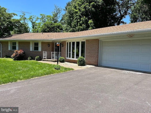 18 Bittersweet Dr, Hagerstown, MD 21740 - ranch-style home featuring brick siding, asphalt driveway, a garage, a front yard, and a shingled roof
