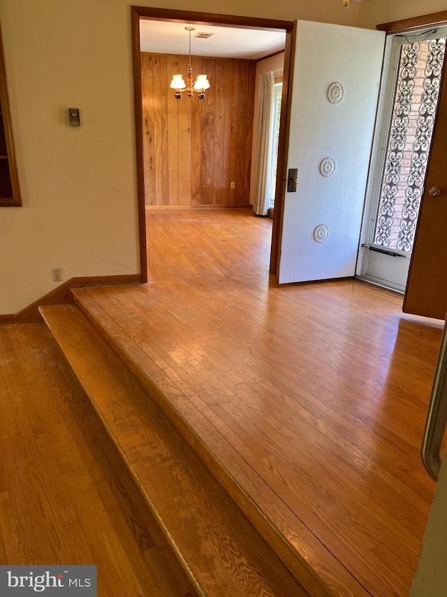18 Bittersweet Dr, Hagerstown, MD 21740 - unfurnished room featuring a chandelier, wood finished floors, wood walls, baseboards, and plenty of natural light