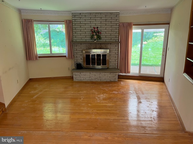 18 Bittersweet Dr, Hagerstown, MD 21740 - unfurnished living room featuring wood finished floors, baseboards, and a brick fireplace