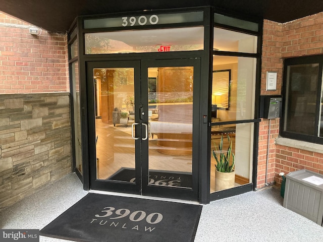 3900 Tunlaw Rd NW Unit 419, Washington, DC 20007 - doorway to property featuring french doors, brick siding, and radiator