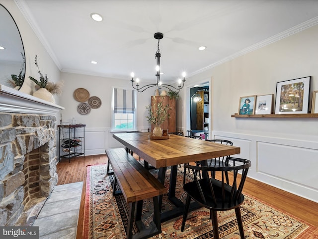 1549 N Jefferson Ct, Lancaster, PA 17602 - dining space featuring a chandelier, wood finished floors, crown molding, a wainscoted wall, and a decorative wall