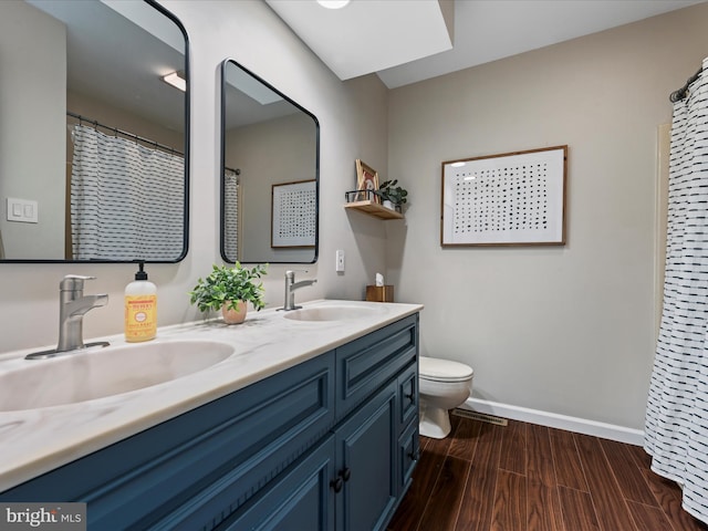 1549 N Jefferson Ct, Lancaster, PA 17602 - full bath featuring double vanity, baseboards, toilet, and wood finished floors