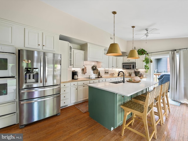 1549 N Jefferson Ct, Lancaster, PA 17602 - kitchen with stainless steel appliances, a sink, ceiling fan, tasteful backsplash, and white cabinetry