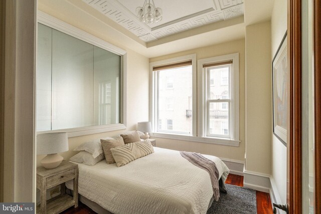 1830 Rittenhouse Sq Unit 11C, Philadelphia, PA 19103 - bedroom featuring a chandelier, multiple windows, dark wood-style floors, and baseboards