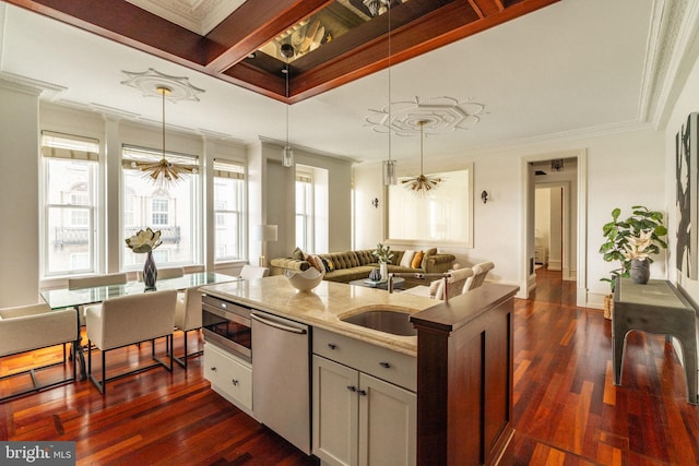 1830 Rittenhouse Sq Unit 11C, Philadelphia, PA 19103 - kitchen featuring stainless steel appliances, ornamental molding, open floor plan, light stone countertops, and a sink