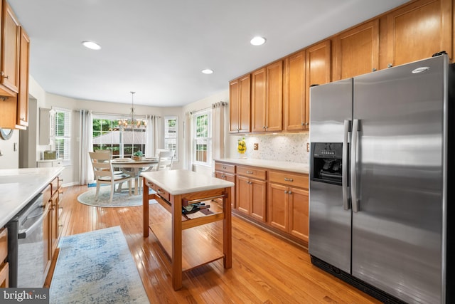 129 Bridle Path Dr, Egg Harbor Township, NJ 08234 - kitchen featuring stainless steel appliances, light countertops, light wood-style floors, a chandelier, and brown cabinetry