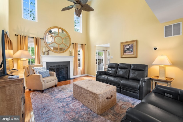 129 Bridle Path Dr, Egg Harbor Township, NJ 08234 - living area featuring a high ceiling, ceiling fan, wood finished floors, a fireplace with flush hearth, and baseboards