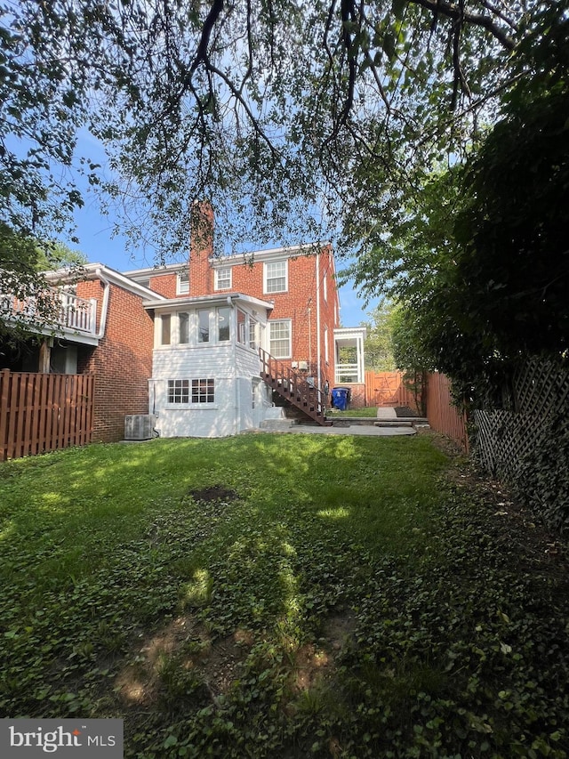 2108 26th St S, Arlington, VA 22206 - rear view of house featuring a fenced backyard, brick siding, and a chimney