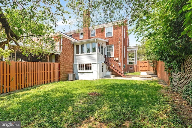 2108 26th St S, Arlington, VA 22206 - rear view of house with a fenced backyard, stairs, and brick siding