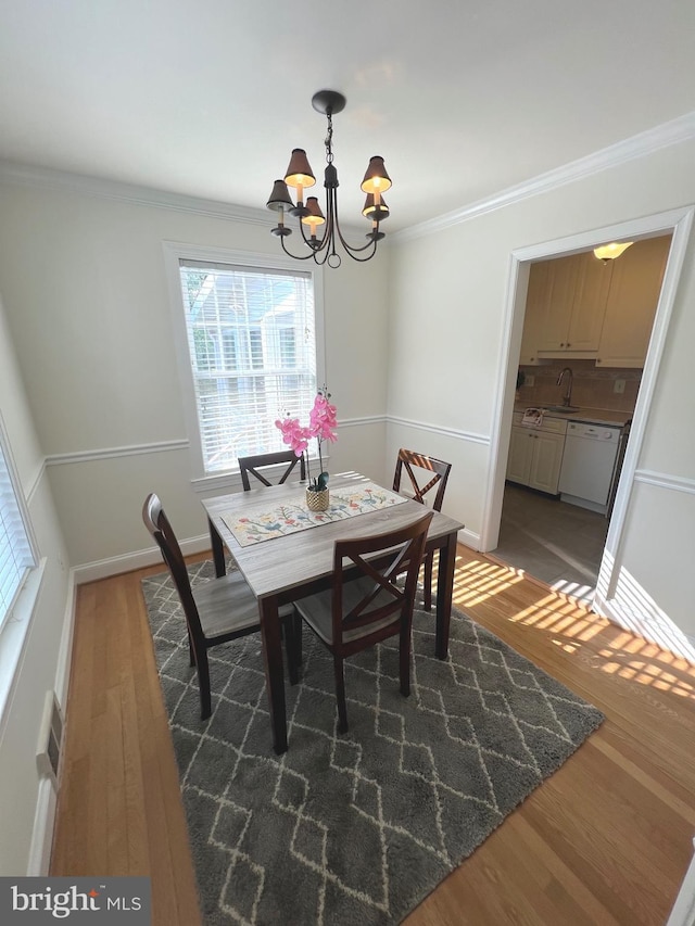 2108 26th St S, Arlington, VA 22206 - dining area with a chandelier, wood finished floors, and crown molding