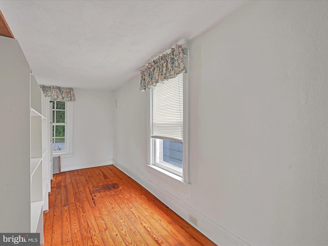 2240 Mahantongo St, Pottsville, PA 17901 - unfurnished room featuring light wood-style flooring, baseboards, and a textured ceiling