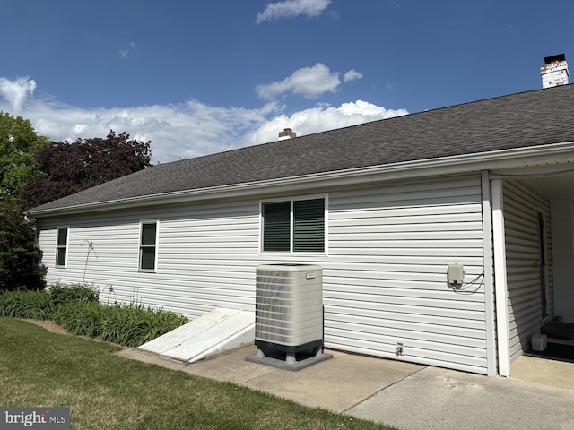 524 S Pitt St, Carlisle, PA 17013 - view of property exterior with cooling unit, a shingled roof, and a chimney