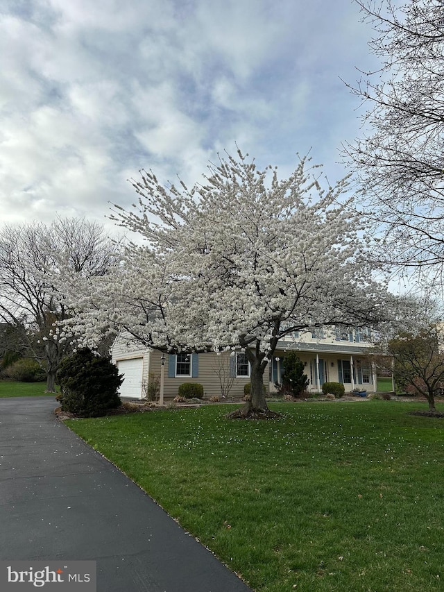 3781 Brookcroft Ln, Garnet Valley, PA 19060 - view of property hidden behind natural elements with a front yard, a garage, and asphalt driveway