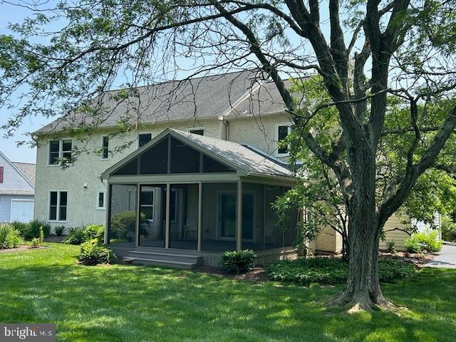 3781 Brookcroft Ln, Garnet Valley, PA 19060 - rear view of property with a sunroom, a lawn, and stucco siding