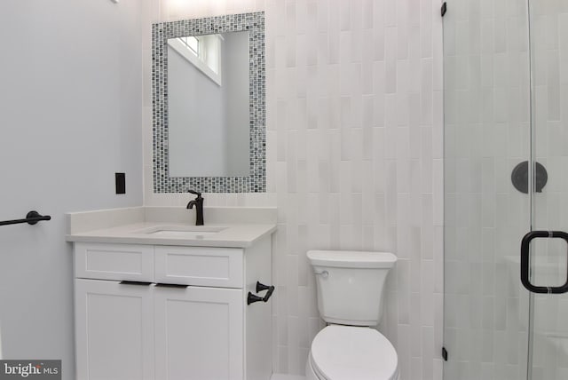 3 Laurel St, Rehoboth Beach, DE 19971 - bathroom with vanity, toilet, a shower stall, and tile walls