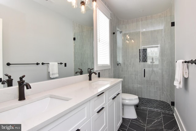 3 Laurel St, Rehoboth Beach, DE 19971 - bathroom with marble finish floors, a stall shower, toilet, double vanity, and healthy amount of natural light