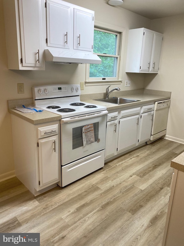204 Marion Ave, Carlisle, PA 17013 - kitchen featuring white appliances, under cabinet range hood, a sink, and light countertops