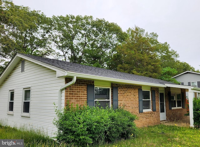 643 University Dr, Waldorf, MD 20602 - view of side of property featuring brick siding and a shingled roof
