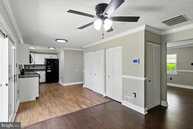 643 University Dr, Waldorf, MD 20602 - kitchen featuring black fridge, a sink, dark wood-style flooring, dark countertops, and ceiling fan