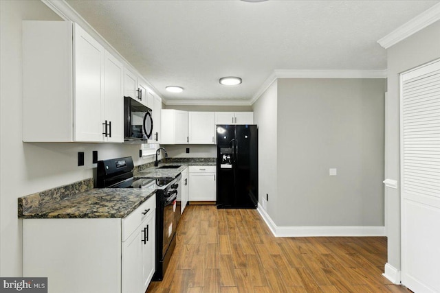 643 University Dr, Waldorf, MD 20602 - kitchen with black appliances, a sink, crown molding, white cabinetry, and wood finished floors
