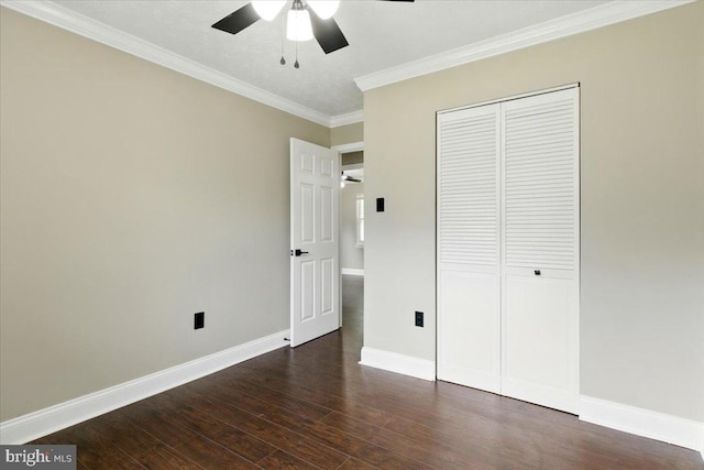 643 University Dr, Waldorf, MD 20602 - unfurnished bedroom featuring dark wood-style floors, ornamental molding, a closet, baseboards, and a ceiling fan