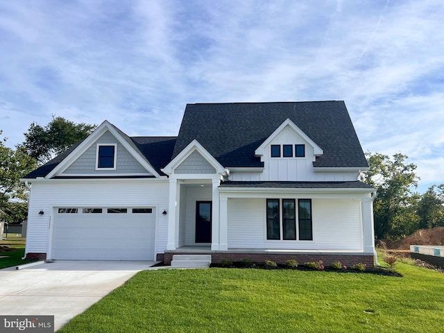 34232 Brenner Ln, Lewes, DE 19958 - view of front of house featuring driveway, a front yard, a shingled roof, and board and batten siding