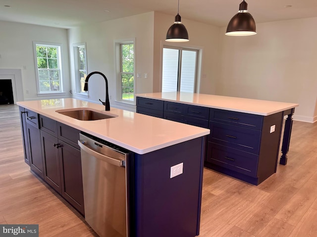 34232 Brenner Ln, Lewes, DE 19958 - kitchen with stainless steel dishwasher, a sink, a center island with sink, and light wood-type flooring