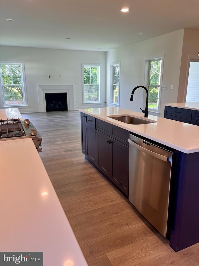 34232 Brenner Ln, Lewes, DE 19958 - kitchen with stainless steel dishwasher, a sink, light countertops, light wood-style floors, and recessed lighting