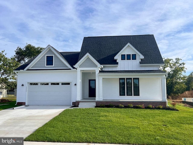 34232 Brenner Ln, Lewes, DE 19958 - view of front of property with driveway, a front yard, a shingled roof, and board and batten siding