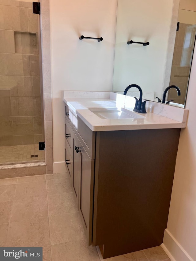 34232 Brenner Ln, Lewes, DE 19958 - bathroom featuring vanity, a shower stall, tile patterned flooring, and baseboards