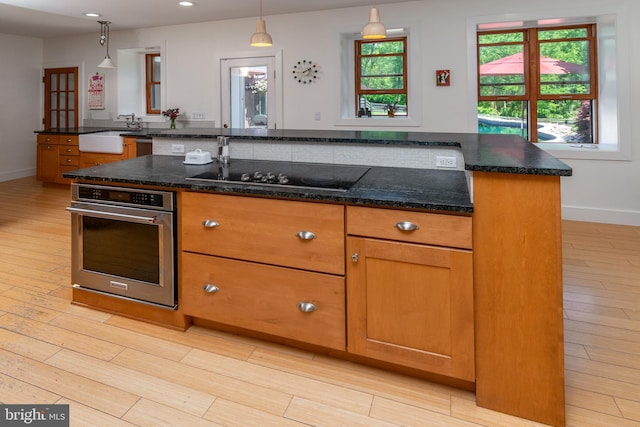 2539 Aquetong Rd, New Hope, PA 18938 - kitchen with stainless steel oven, black electric stovetop, a sink, light wood-style flooring, and recessed lighting
