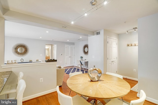 4149 S Four Mile Run Dr Unit 201, Arlington, VA 22204 - dining room with light wood-style flooring, rail lighting, recessed lighting, and baseboards